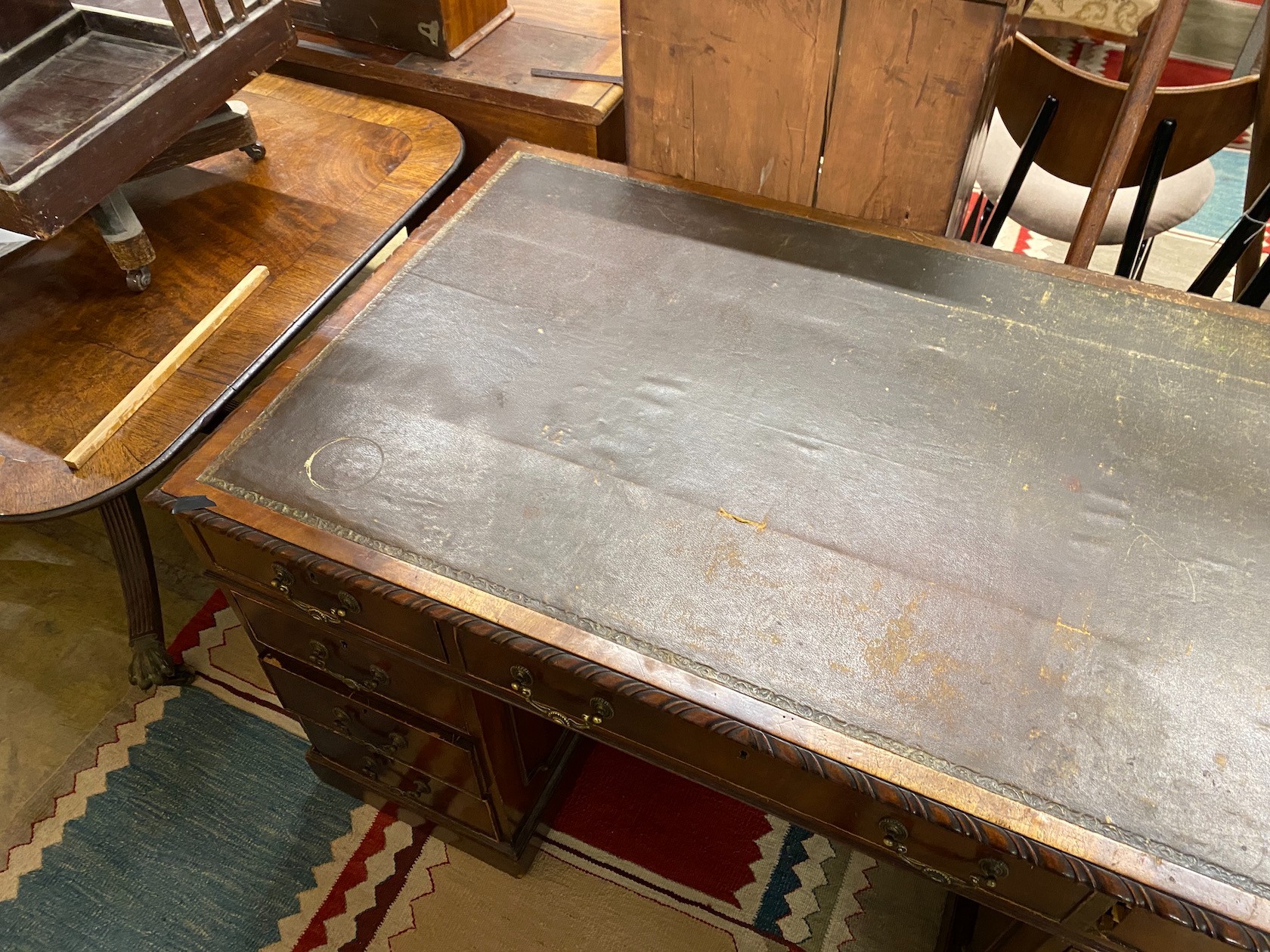 An early 20th century Chippendale revival mahogany pedestal desk, requiring restoration, length 135cm, depth 79cm, height 73cm